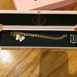 Juicy Couture gold butterfly bracelet .&case
